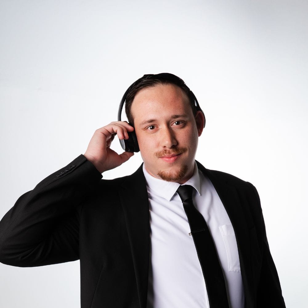 Drew in a suit with DJ headphones on