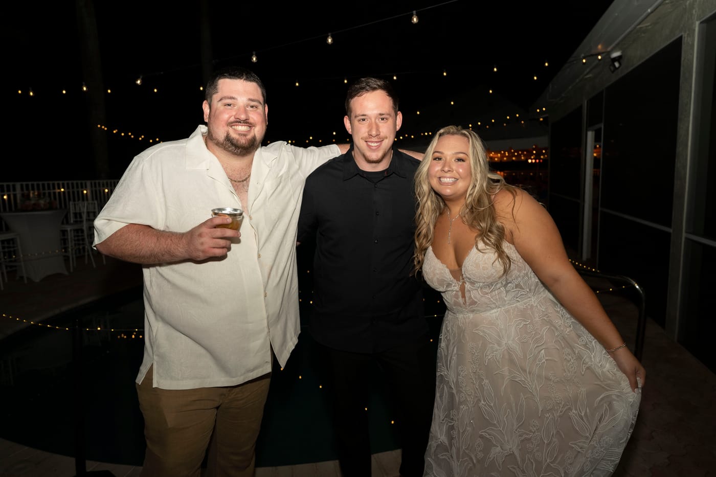 Drew with a bride and groom at their wedding